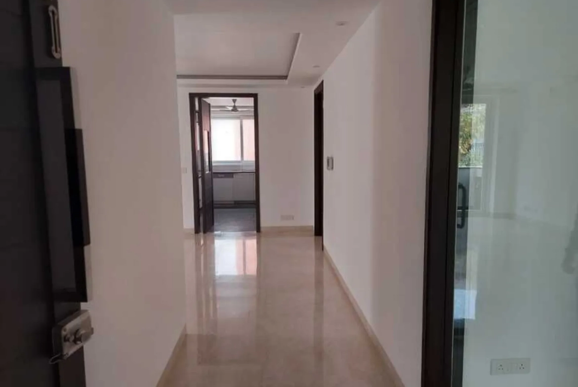 "Modern apartment hallway leading to kitchen, interior view, ready to move, South Delhi."