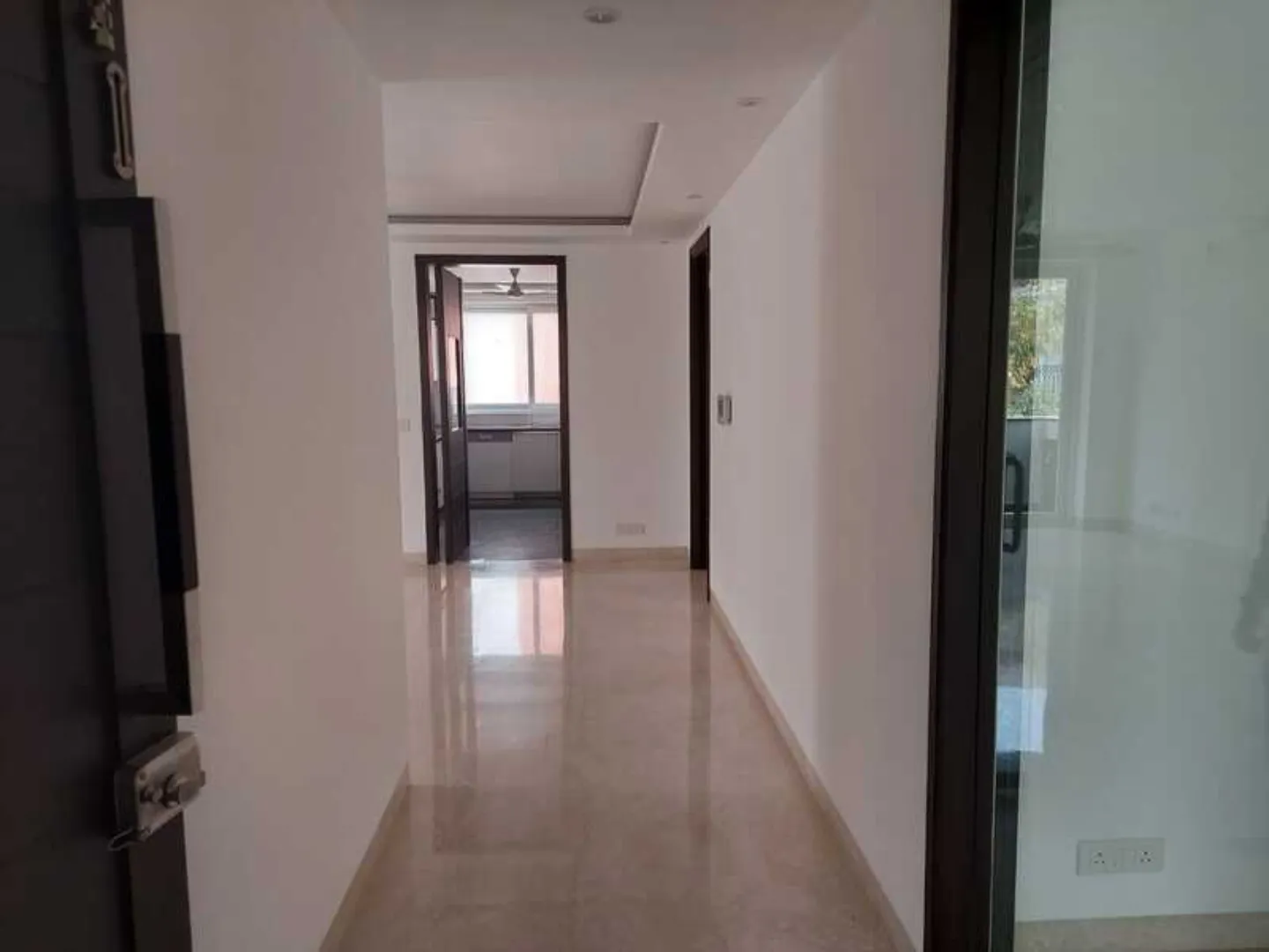 "Modern apartment hallway leading to kitchen, interior view, ready to move, South Delhi."